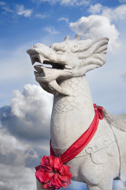 Qilin on a background of clouds clipart