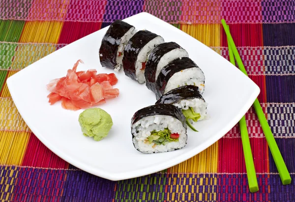Sushi with ginger and wasabi on a white plate — Stock Photo, Image