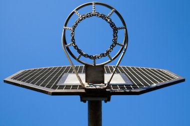 Metal basketball hoop on blue sky clipart