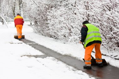 Workers removing first snow