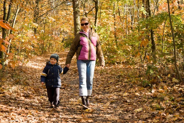 Mother and son in autumn forest — Stock Photo, Image