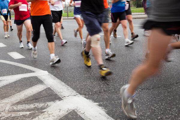 Running in marathon on a street in intentional motion blur