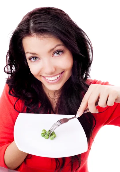 エンドウ豆を食べる女性 — ストック写真