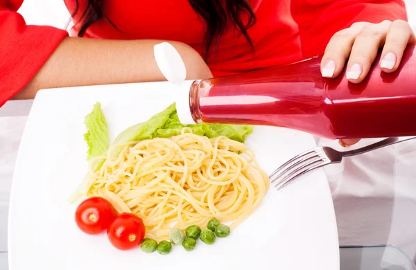 stock image Woman eating spaghetti with ketchup