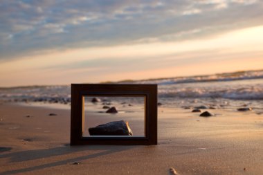Frame on the beach at sunset clipart