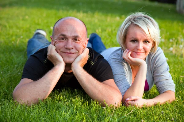 Adult happy couple together on grass — Stock Photo, Image