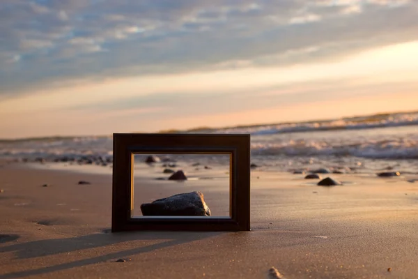 Frame on the beach at sunset — Stock Photo, Image