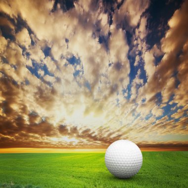 Playing golf. Ball on golf field at sunset clipart