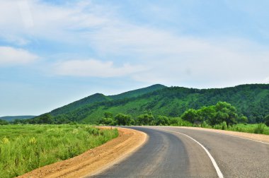 Country road clouds and hill 'sopka'