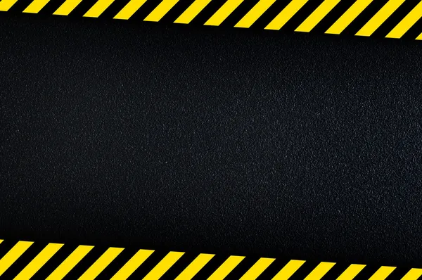 Dark background with yellow caution stripes — Stock Photo, Image