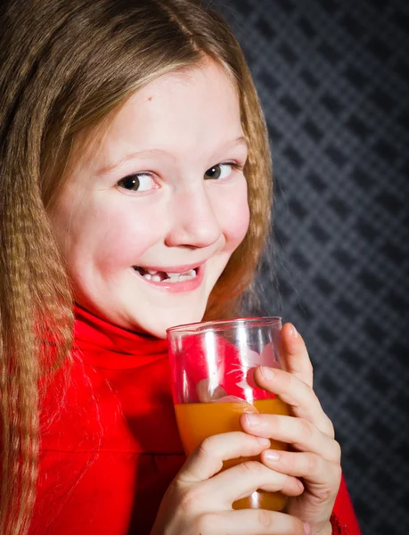 Beautiful little girl with glass in hands — Stock Photo, Image