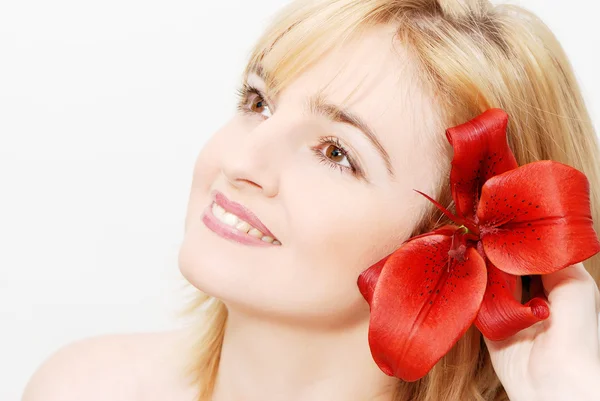 Retrato de una hermosa mujer con una flor — Foto de Stock