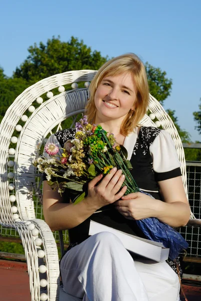 Красива жінка з купою квітів в руках — стокове фото