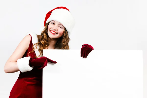 Kadın santa Noel beyaz kartı tutan — Stok fotoğraf