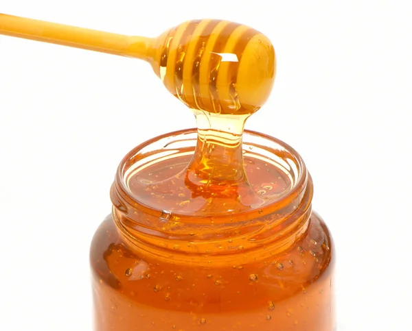 Miel goutteur et pot de miel isolé sur fond blanc — Photo