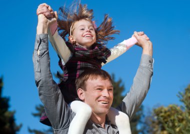 Father and daughter against sky clipart