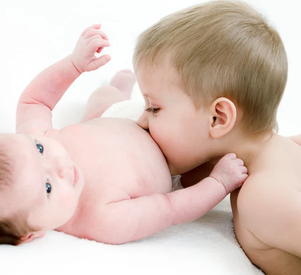 Pequeño chico beso su recién nacido hermana — Foto de Stock
