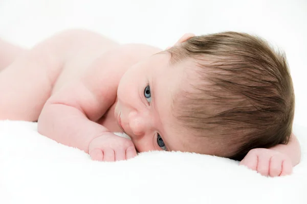 Close up portrait newborn baby lying in bed — Stock Photo, Image