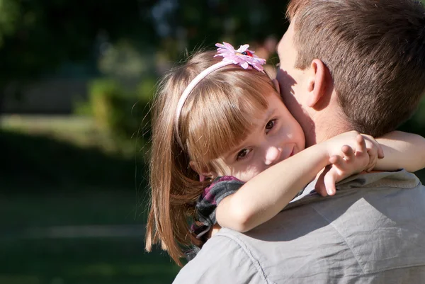 A pequena menina feliz em um ombro do pai — Fotografia de Stock