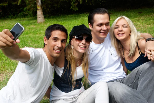 Ευτυχισμένη ομάδα φίλων που είναι χαμογελώντας σε εξωτερικούς χώρους σε ένα πάρκο — Φωτογραφία Αρχείου