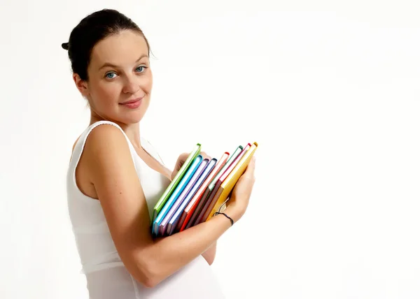 Die schwangere Frau mit Büchern auf hellem Hintergrund — Stockfoto