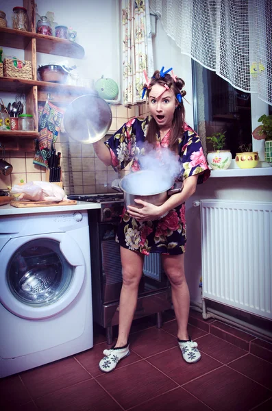 La stupide femme au foyer avec une casserole dans les mains — Photo
