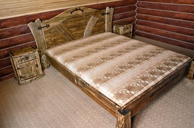 Bedroom with old-style wooden bed clipart