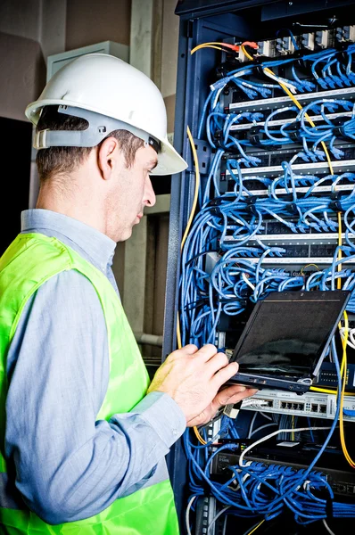 stock image Engineer in network server room solving problems