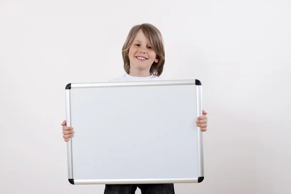Boy holding white drawing board — Stock Photo, Image