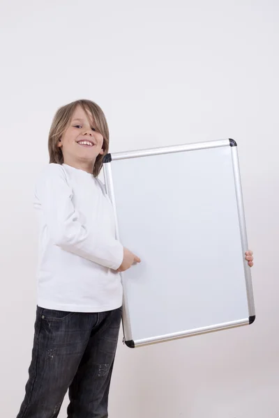 Niño sosteniendo tablero de dibujo blanco . — Foto de Stock