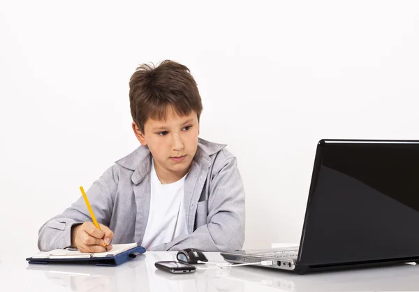 Young boy taking notes — Stock Photo, Image