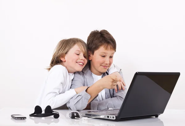 Two cheerful boys looking something on lap top — Stock Photo, Image