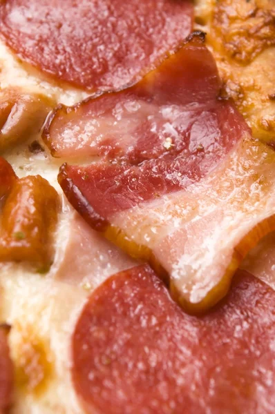 stock image Italian pizza with bacon, salami and mozzarella cheese