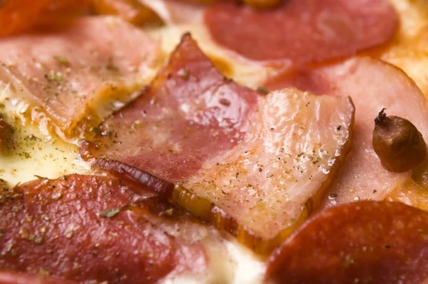 stock image Italian pizza with bacon, salami and mozzarella cheese