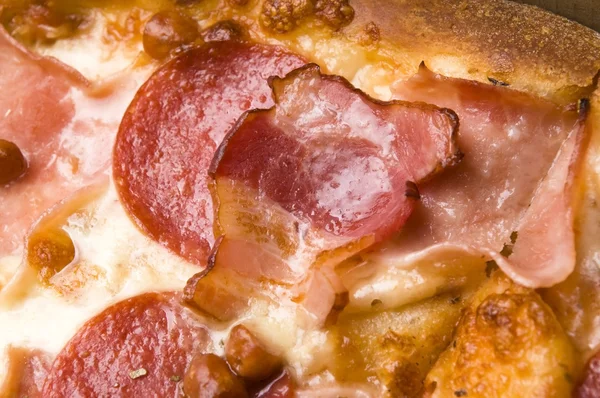 stock image Italian pizza with bacon, salami and mozzarella cheese