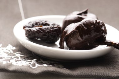 Dried plums in chocolate clipart