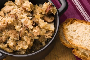 Traditional polish sauerkraut (bigos) with mushrooms and plums f clipart