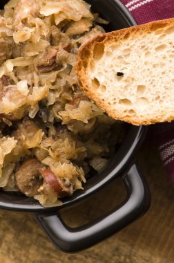 Traditional polish sauerkraut (bigos) with mushrooms and plums f clipart