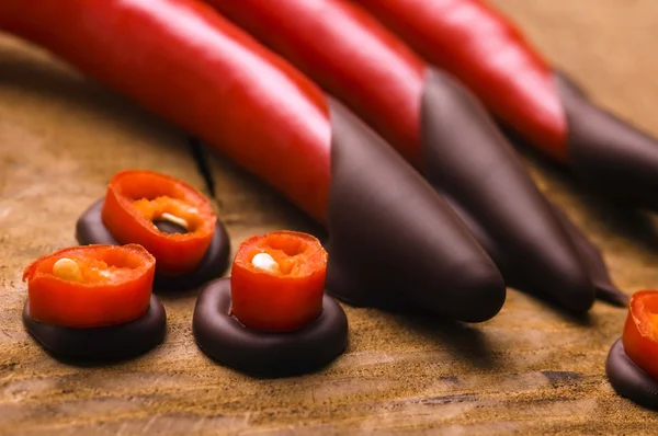 Red hot chilli pepper with dark chocolate — Stock Photo, Image