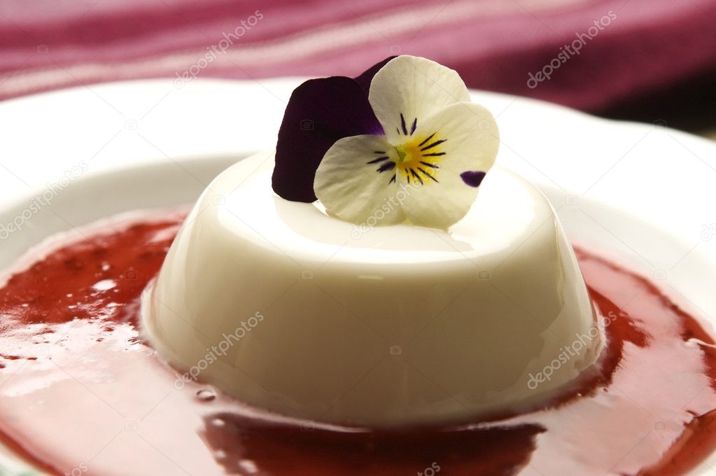 Vanilla panna cotta with berry sauce and spring flower
