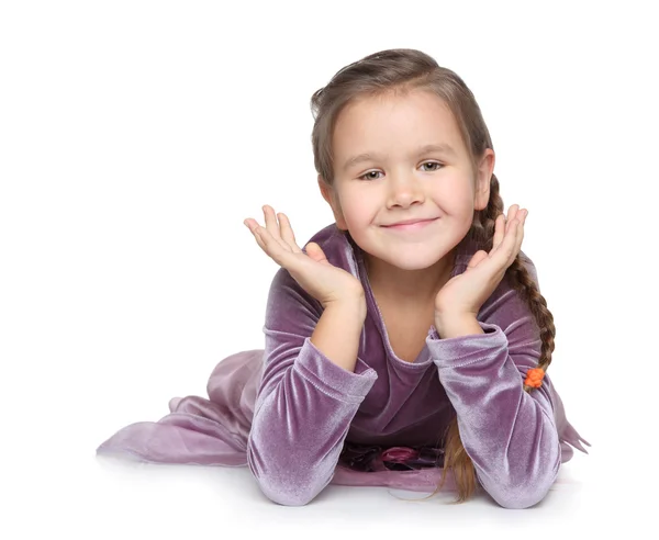 Happy little girl lies on floor and smile — Stock Photo, Image