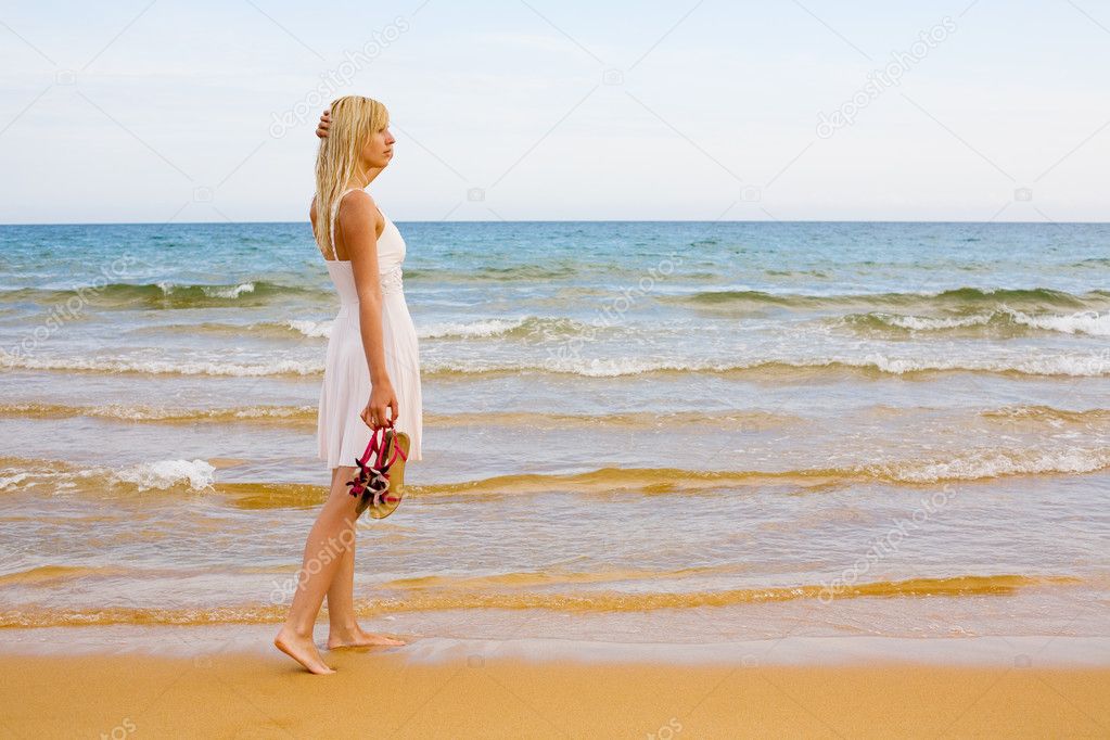 Girl standing by sea