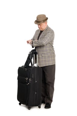 Traveler with luggage looks at his watch clipart