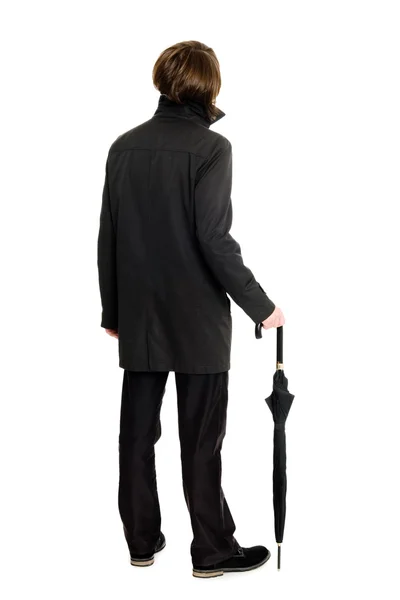 Elegant man in a raincoat standing back — Stock Photo, Image