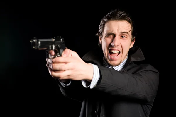 Man shooting a gun — Stock Photo, Image