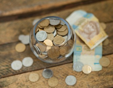 Ukrainian coins and hryvnas shows poverty clipart