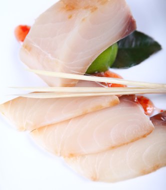 Raw white fish with sauce clipart