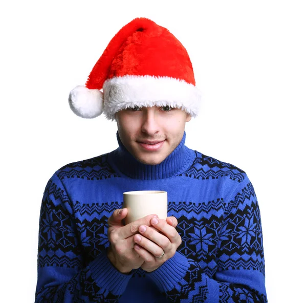 Mann mit Weihnachtsmannmütze mit Tasse — Stockfoto