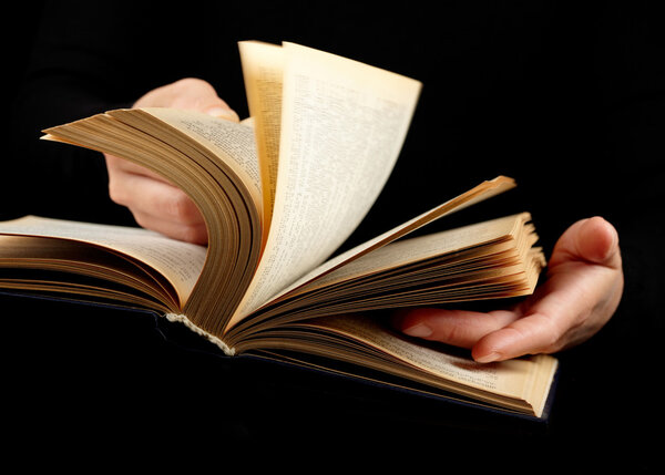 Looking thruogh book with motion blur on black background