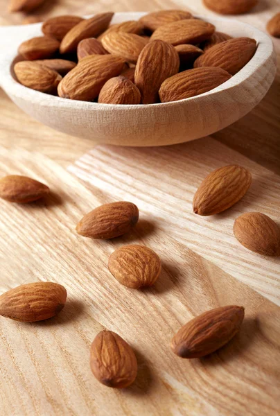 Almonds on wooden background — Stock Photo, Image